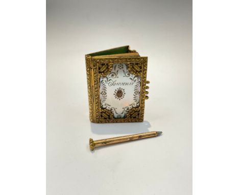 A French ornate gilt and mother-of-pearl engraved "Souvenir" aide memoir with blue enamel pansy motif to front and back centr