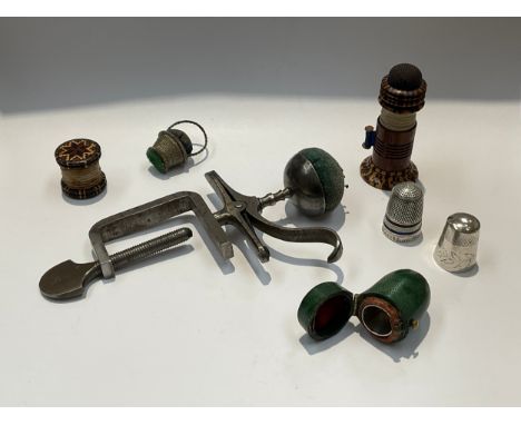 A collection of sewing related items including Tunbridge Ware needle case, pin cushion, waxer, a silver thimble with enamelle