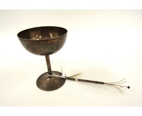 A William Hutton &amp; Sons Ltd., champagne saucer and sterling silver twizzle stick, Sheffield 1910, 106g, the saucer is cre
