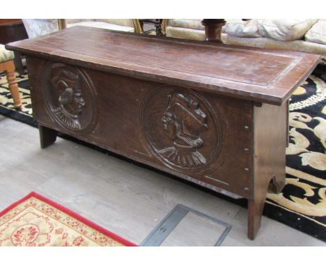 A Jack Grimble, Cromer, carved oak coffer with Tudor style carved portrait panels, 121.5cm x 44cm x 56cm 