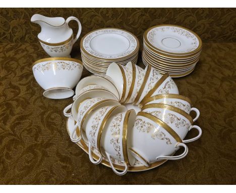 Royal Doulton Belmont gilt decorated teaset comprising 12 cups, 11 saucers, 12 tea plates, cake plate, sugar and cream.  38 p