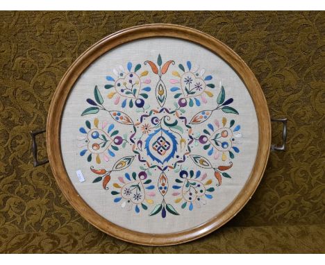Mahogany tea tray with brass handles and needlework panel.