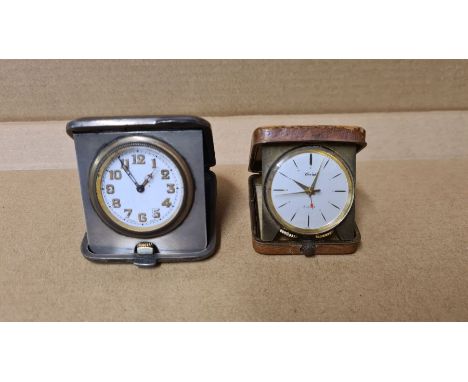 Silver cased travel clock and a leather cased travel alarm clock.