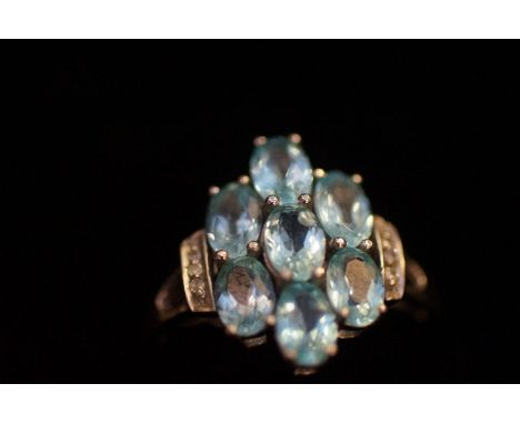 9ct White Gold Ring with 7 Light Blue Stones and Diamonds