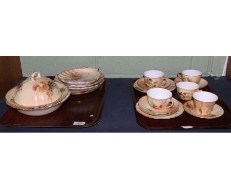 A set of three Royal Worcester porcelain teacups and saucers, 1910, decorated with flowers on an ivory ground, printed mark; 