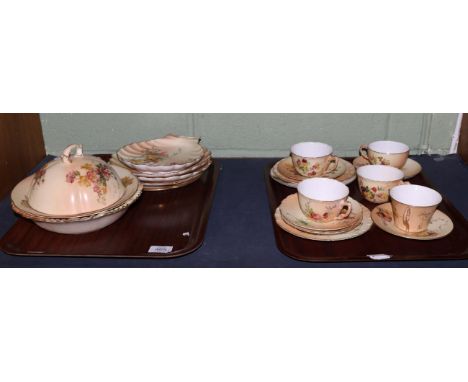 A set of three Royal Worcester porcelain teacups and saucers, 1910, decorated with flowers on an ivory ground, printed mark; 