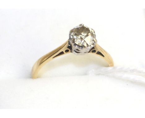 An 18 carat gold diamond solitaire ring, an old cut champagne diamond in a white claw setting with an extended underbezel, to