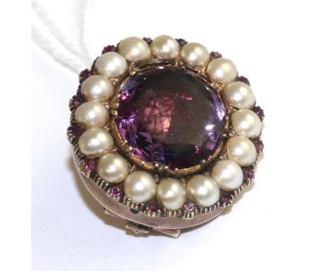 An amethyst and split pearl brooch, an oval cut foil backed amethyst in a yellow collet and claw setting, within a border of 