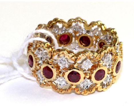 A ruby and diamond eternity ring, round cut rubies in yellow rubbed over settings, spaced by pairs of round brilliant cut dia