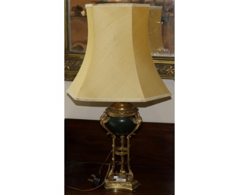 A gilt and patented metal lamp base, late 19th century, modelled as an urn with swan support on a triform base, 34.5cm high, 