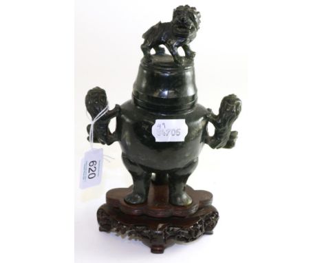 # A Chinese spinach jade censer and cover, 19th century, carved with lion dogs, 20cm high, on wooden base (a.f.)