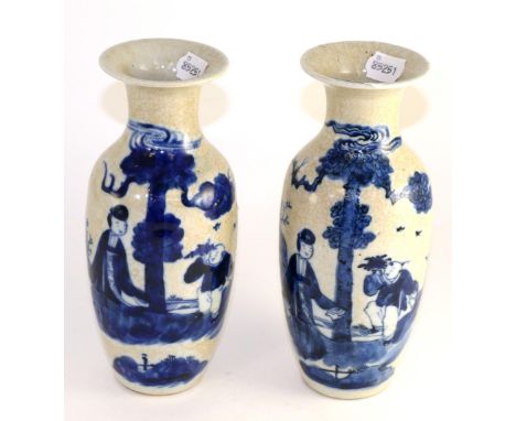 A pair of Chinese crackle glaze baluster vases, painted underglaze blue with figures in landscape, bears Kangxi reign mark, 2