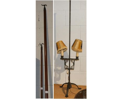 A 17th century style iron twin light floor candelabrum, 123cm high, adapted for electricity; and two window poles (3)