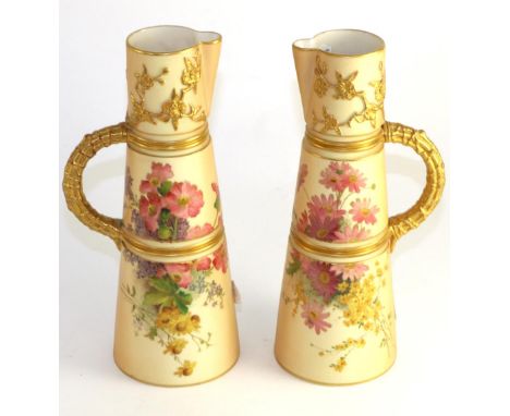 A pair of Royal Worcester porcelain ewers, 1904, modelled with prunus and painted with flower sprays on an ivory ground, 25.5