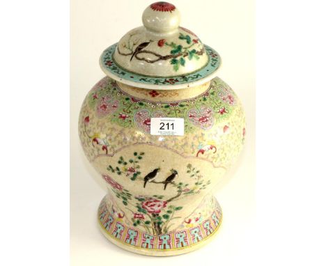 A Chinese crackle glaze baluster jar and cover, painted in famille rose enamels with birds amongst foliage within foliate bor