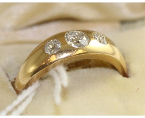 A diamond three stone ring, graduated old cut diamonds drill set into a plain polished flat sided shank, total estimated diam