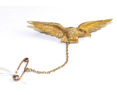 An eagle brooch, modelled with spread wings and a ruby cabochon eye, measures 5.2cm long The brooch is in good condition. It 