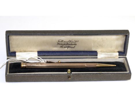 A 9 carat gold propelling pencil, with engine turned decoration, in a Farttorini & Sons Ltd caseThe pencil is in good conditi