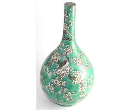 A Chinese porcelain bottle vase, Kangxi reign mark but not of the period, painted in famille vert enamelled with birds amongs