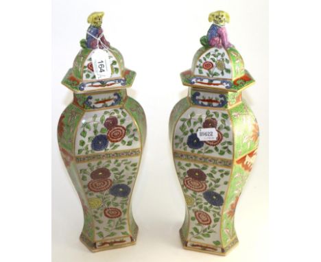 A pair of Sampson of Paris hexagonal baluster vases and covers painted in Worcester style with Kakiemon style foliage, 42cm h