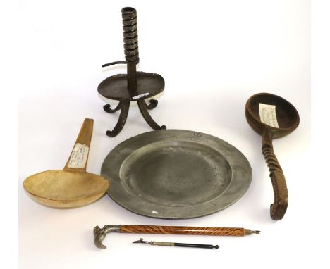 A pewter plate, a rush light holder, a horn milk skimmer, a carved spoon and a small parasol handle 
