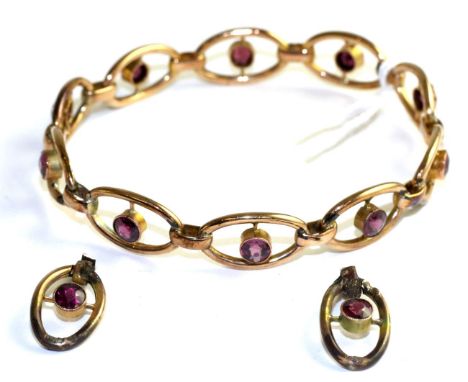 A garnet bangle, round cut garnets in yellow milgain settings, to pierced oval links, measures 7cm by 6.3cm in diameter The b