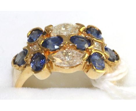 A sapphire and diamond cluster ring, eight oval cut sapphires with two marquise cut diamonds and two princess cut diamonds in