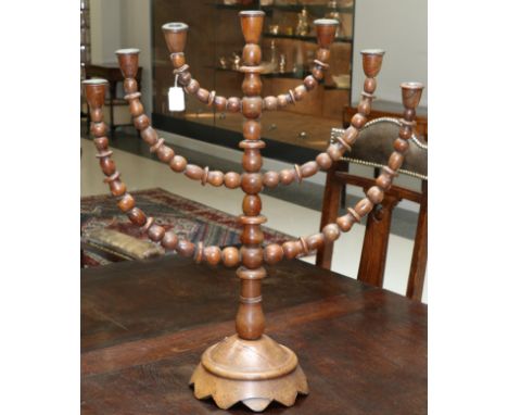 A turned wood Menorah lamp, 19th century, with bobbin turned branches and column on domed base, 67.5cm high 