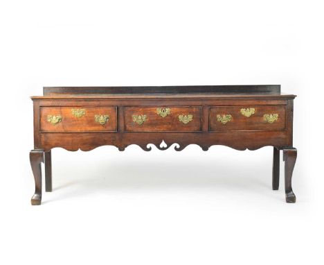 A good early-mid 18th century oak dresser base, the later gallery back over a rectangular top with a scotia moulded edge, abo