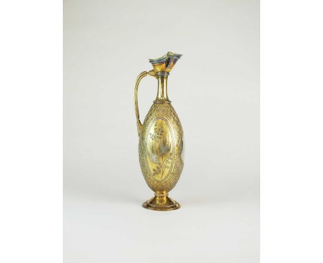 An early Victorian silver gilt wine ewer, Elkington &amp; Co., London 1859, of elongated oval form with graduated diamond gro