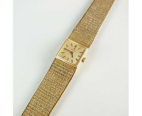 A 9ct gold Omega bracelet wristwatch, the square dial with batons, manual wind, with attached tapering textured Omega bracele