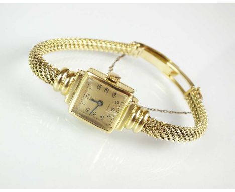 A Lady’s 14ct gold Este bracelet wristwatch, the square champagne dial with black Arabic numerals, manual wind, the decorativ