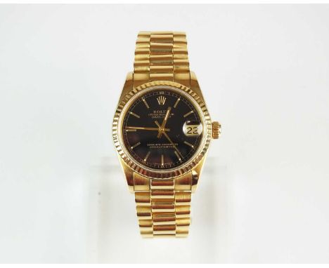 An 18ct gold mid-size Rolex Oyster Perpetual Datejust Superlative Chronometer wristwatch, the black dial with gold batons, da