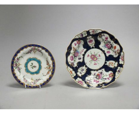 A Worcester porcelain platecirca 1770painted with shaped rococo-style panels of flowers reserved against a scale blue ground,