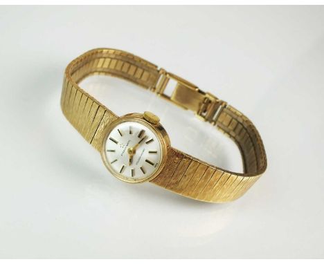 A Lady's 9ct gold Eterna-Matic wristwatch, the circular dial with batons, manual wind, with attached textured graduated brick