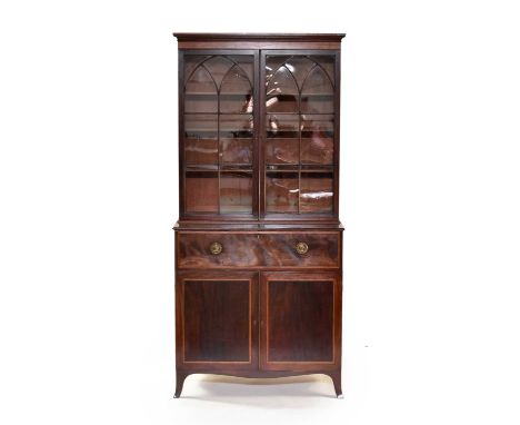 A George IV mahogany secretaire bookcase, inlaid with ebony stringing and banded with stained sycamore, the cavetto cornice a