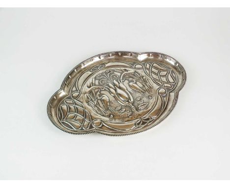 An Art Nouveau silver dressing table tray, William Aitken, Birmingham 1906, of lobed form with embossed heron and reed decora