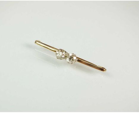 A two stone diamond brooch, the old cut diamonds claw set in white metal and mounted to yellow metal bar, 37mm wide, not stam