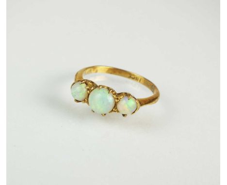 A graduated three stone opal ring, the three cabochon opals claw set in yellow metal to yellow metal shank, stamped '18ct', r