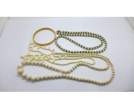 An ivory bead necklace, a necklace and matching bracelet, a bangle and a faux pearl necklace 