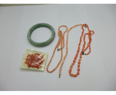 A jade bangle, two coral necklaces, a coral bracelet and loose coral 