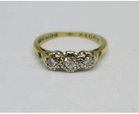 An 18ct gold, three stone diamond trilogy ring, 2.3g, K 