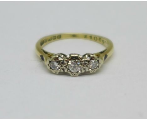 An 18ct gold, three stone diamond trilogy ring, 2.3g, K 