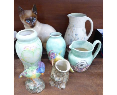 Four items of Radford pottery, pitcher, jug, vase and bird vase, a figure of bird, a Babbacombe pottery Siamese cat and one o