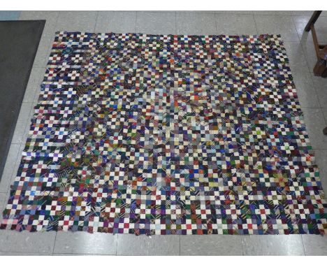 A painted silk panel of a peacock, four small circular pieces and an unfinished patchwork panel 