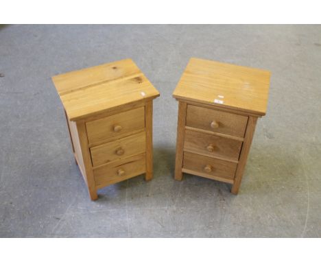 A pair of modern light oak and pine bedside chests, each with three drawers 62cm x 42cm x 36cm some wear and marks to tops ot
