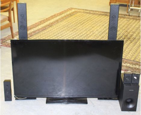 A DigiHome 50" flatscreen television together with a Samsung surround sound speaker system, used condition but appears good, 