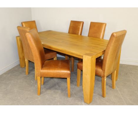 A large blocked light oak dining table 76cm x 199cm 100cm and six brown leather upholstered dining chairs 104cm high x 45cm w