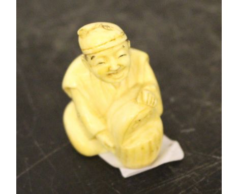 A small Japanese carved ivory netsuke, seated gentleman, 4.5cm head damaged.