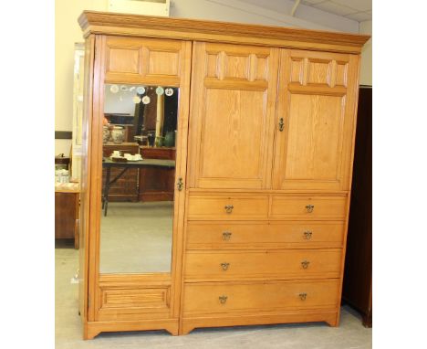 A Victorian Gregory &amp; Co ash mirror door wardrobe, the moulded cornice with geometric carving over a long panelled mirror